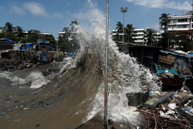 A wave breaks along a seafront during high tide in Mumbai, India. REUTERS/Francis Mascarenhas